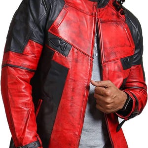 May include: A red and black leather jacket with a distressed finish. The jacket features a stand-up collar, a zip-up front, and black panels on the shoulders and sleeves. The jacket has a buckle detail on the sleeve.