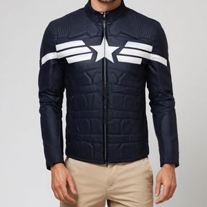 May include: Navy blue quilted jacket with a white star and stripe design on the chest. The jacket has a stand-up collar and a full-length zipper. The sleeves are long and the jacket is paired with khaki pants.