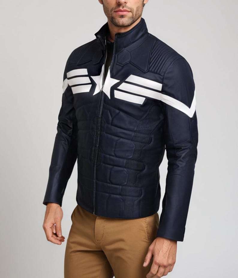 May include: Navy blue jacket with white star and stripe design. The jacket has a quilted pattern on the front and a stand-up collar. The sleeves are long and the jacket is zipped up. The jacket is worn with khaki pants.