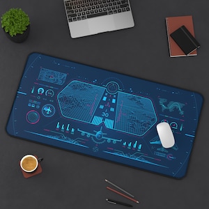 May include: A blue desk mat with a detailed aviation-themed design. The mat features a runway graphic, an airplane illustration, and various digital display elements. A white mouse rests on the mat, alongside a laptop and other office supplies.