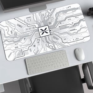 May include: A rectangular desk mat featuring a white background with a black printed circuit board pattern. The center of the mat displays a square logo containing the text STEALTH with an X symbol. The design includes various lines and dots.