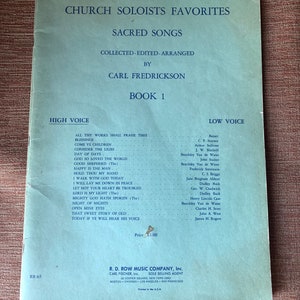 May include: A blue book titled "Church Soloists Favorites: Sacred Songs" with the words "Collected-Edited-Arranged by Carl Fredrickson Book 1" printed on the cover. The book lists songs for both high and low voices.