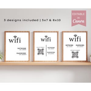 May include: Three framed prints with a WiFi theme. Each print has a wooden frame and a white background with the word "wifi" and network and password information. The prints are displayed on a wooden shelf with plants.