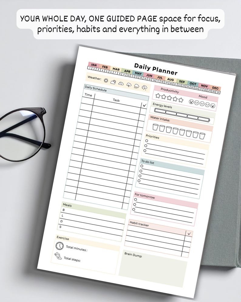 May include: A daily planner with sections for scheduling, productivity, and habit tracking. The planner includes space for time, tasks, weather, energy levels, water intake, priorities, a to-do list, and a brain dump. The text "YOUR WHOLE DAY, ONE GUIDED PAGE space for focus, priorities, habits and everything in between" is at the top.