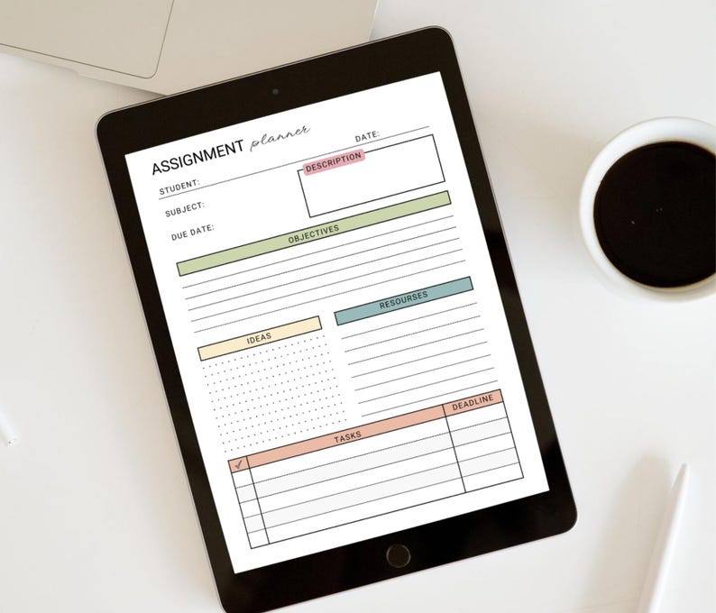 May include: A black tablet displaying a digital assignment planner. The planner includes fields for student, subject, due date, description, objectives, resources, ideas, tasks, and deadline. The text "ASSIGNMENT planner" is at the top. A cup of coffee and a laptop are in the background.