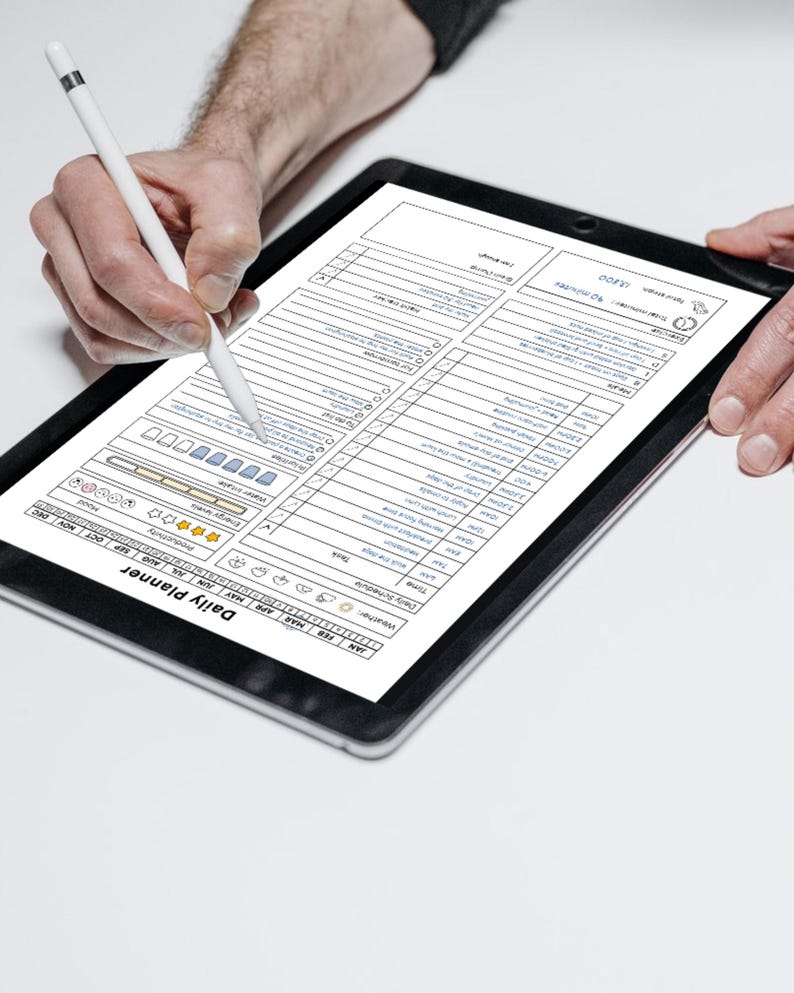 May include: A black tablet displaying a daily planner template with sections for tasks, weather, and energy levels. A white stylus is used to interact with the digital planner. The text "Daily Planner" is visible.