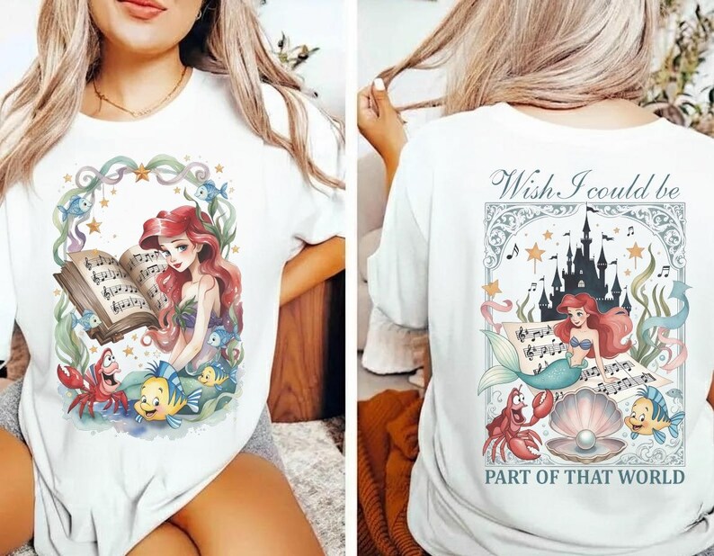 May include: White t-shirt featuring a colorful illustration of a mermaid reading sheet music, surrounded by sea creatures. The back of the shirt has a matching design with the text "Wish I could be part of that world."