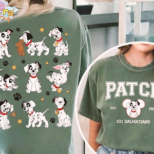 May include: Green t-shirts featuring a 101 Dalmatians theme. One shirt has a graphic of multiple Dalmatian puppies with paw prints and stars. The other shirt has the word "PATCH" above a Dalmatian graphic and the text "EST. 1961".