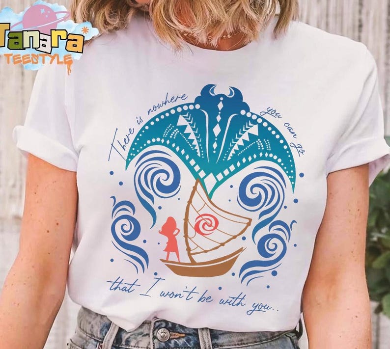 May include: A white short-sleeve t-shirt featuring a graphic of a blue manta ray, a brown sailboat, and a red silhouette of a person. The text reads, There is nowhere you can go that I won't be with you. The design includes blue swirling wave patterns.