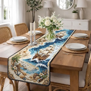 May include: A nautical-themed table runner featuring a detailed illustration of a ship sailing on a blue ocean. The design includes elements like waves, seashells, and a sandy beach. The runner is placed on a wooden table, enhancing the coastal theme.