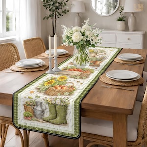 May include: A rectangular table runner with a green and white checkered border. The center features a floral and harvest-themed design with sunflowers, baskets of fruit, and gardening boots. The runner is placed on a wooden dining table set with plates, candles, and a vase of flowers.