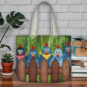 May include: A quilted tote bag with a design of five blue chickens with red crests, looking over a brown fence. The chickens are adorned with bandanas and scarves. The background is a green forest, and the bag has a cream handle.