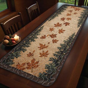 May include: A quilted table runner with a seasonal autumn design. The runner has a beige central panel with scattered brown leaves. The edges are trimmed with a dark brown border and a pattern of green fir trees. It is placed on a wooden table.