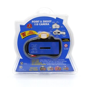 May include: A blue and black point and shoot 110 camera with a yellow viewfinder. The packaging says "Try Me!" and "100% Larger Viewfinder".
