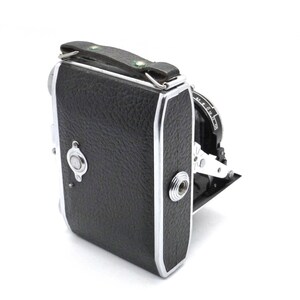 May include: A vintage folding camera with a black leather covering and a carrying handle. The camera is made of silver and black.