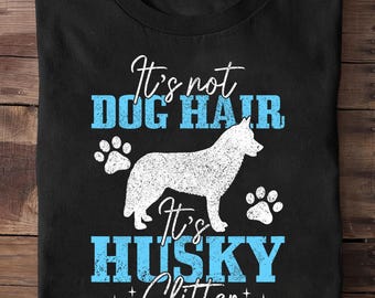 May include: Black t-shirt with the text "It's not DOG HAIR, It's HUSKY Glitter." A white husky dog silhouette and paw prints are featured in the design. The text and dog are in white, with the words "DOG HAIR" and "HUSKY" in blue.