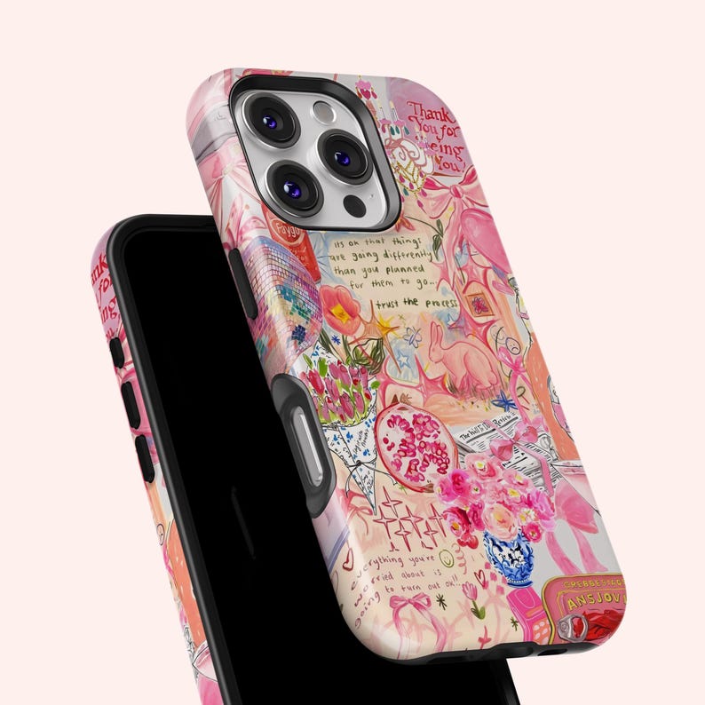 May include: A pink and white phone case with a colorful, artistic design. The case features a collage of flowers, text, and a rabbit illustration. Text includes "Thank you for being you" and "Trust the process."