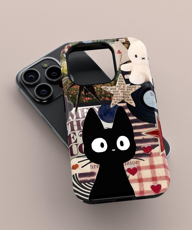 May include: A black phone case featuring a cartoon black cat with white eyes and whiskers. The case has a collage design with a teddy bear, vinyl record, and red hearts. The background includes text and a red and white checkered pattern.