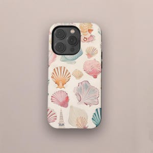 May include: A white phone case with a pattern of colorful seashells. The case has a camera cutout and a black border.