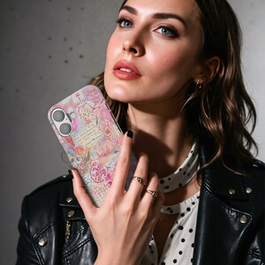 May include: A phone case with a colorful floral and script design. The case features pink, yellow, and blue hues with a vintage aesthetic. The text "Thank you for being you" is visible on the case.