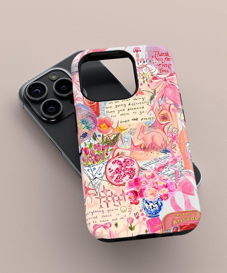 May include: A pink and white phone case with a colorful collage design. The case features illustrations of flowers, a rabbit, a disco ball, and text that reads "Thank You for being You" and "trust the process."