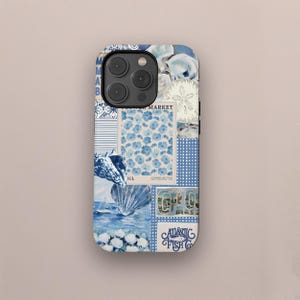 May include: A phone case with a collage design featuring blue and white imagery. The design includes floral patterns, seashell illustrations, and the text "Atlantic Fish Co." and "Market". The case has a glossy finish.