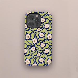 May include: A navy blue phone case with a repeating floral pattern. The design features light green leaves and small, light pink flowers. The case has a rounded rectangular shape with a camera bump.