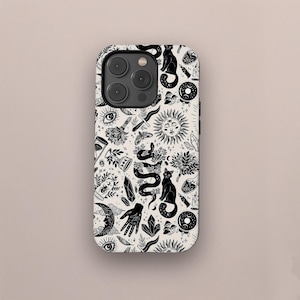 May include: A phone case with a black and white pattern featuring mystical symbols. The design includes a snake, sun, moon, cat, eye, hand, and other occult-themed illustrations. The case has a glossy finish and is designed for a smartphone.