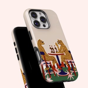May include: A phone case with a design of two cheetahs at a table with beer bottles and a cigarette. The cheetahs are wearing boots and sitting on chairs. The case has a cream-coloured background.