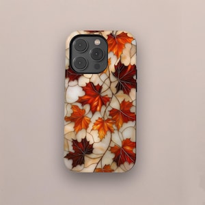 May include: A phone case featuring a stained-glass design of autumn maple leaves in shades of red, orange, and brown. The leaves are set against a cream-colored background with brown vein-like lines. The case has a glossy finish.