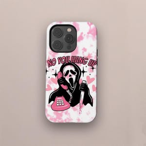 May include: A pink and white tie-dye phone case with a black and white illustration of a ghost holding a knife and a pink phone. The text "NO YOU HANG UP" is printed on the case.