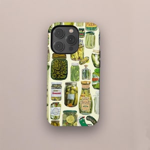 May include: A phone case with a repeating pattern of pickle jars. The jars contain green pickles and have different labels. The background is a light yellow colour.