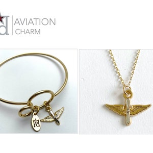 May include: Gold bangle bracelet with a charm of a propeller airplane with wings and a small charm with the letters "FA" and a star. A gold chain necklace with a pendant of a propeller airplane with wings.