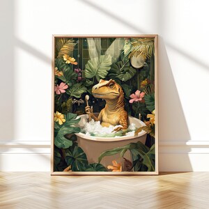 May include: A framed art print depicts a dinosaur relaxing in a bathtub filled with bubbles. The dinosaur is holding a washcloth, surrounded by lush green foliage and colorful flowers. The artwork has a whimsical and playful theme.