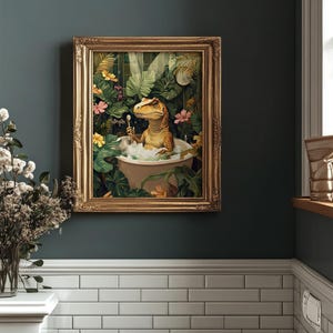 May include: A framed art print depicts a dinosaur relaxing in a bathtub filled with bubbles. The artwork features a gold frame and a lush, tropical background with vibrant flowers and foliage. The dinosaur is holding a toothbrush.