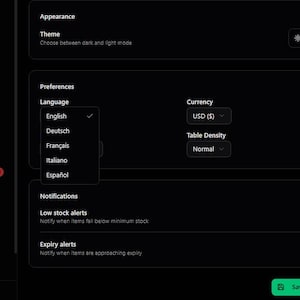 May include: A dark-themed interface with options for appearance, preferences, and notifications. The language selection menu is open, showing English, Deutsch, Fran&ccedil;ais, Italiano, and Espa&ntilde;ol. Currency is set to USD, and table density is normal.