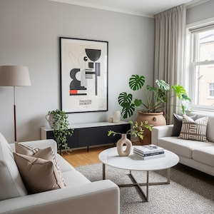 May include: A modern living room with a white sofa, round marble coffee table, and a black and white cabinet. A large framed abstract art piece hangs on the wall. Potted plants and decorative pillows add warmth to the space.