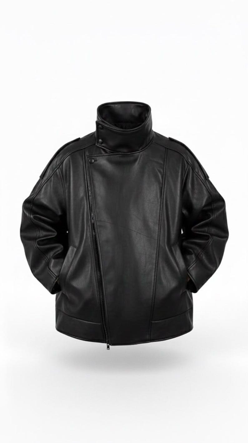 May include: A black leather jacket with a high, buttoned collar and an asymmetrical zipper closure. The jacket has a relaxed fit, with pockets and shoulder detailing. The overall design is sleek and modern, suitable for various styles.