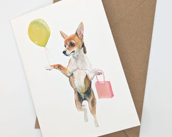 May include: A white and brown chihuahua with a yellow balloon and a pink shopping bag. The chihuahua is standing on its hind legs and holding the balloon in its mouth. The chihuahua is looking to the left. The background is white.
