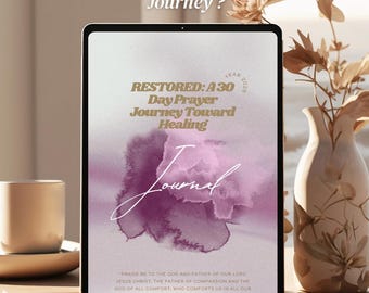May include: A digital tablet displays a journal cover with the text "RESTORED: A 30 Day Prayer Journey Toward Healing." The journal has a watercolor floral design in shades of purple. The words "Available Now" are at the bottom.