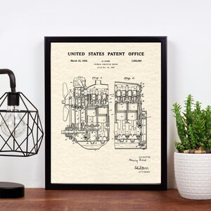 May include: A black and white patent drawing of a four-cylinder internal combustion engine. The drawing is framed in a black frame and is hanging on a wall. The text on the drawing reads "United States Patent Office" and "March 12, 1918".