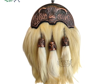 May include: A traditional Scottish kilt sporran with a copper-colored metal top featuring a Highland cow design and Celtic knotwork. The sporran has a light-colored fur body and three decorative tassels.