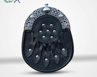 May include: Black leather sporran with a silver Celtic knot design. The sporran features a circular embossed pattern with silver studs and leather tassels. The top has a silver metal clasp. The logo "Kilt Craze" is in the top left corner.
