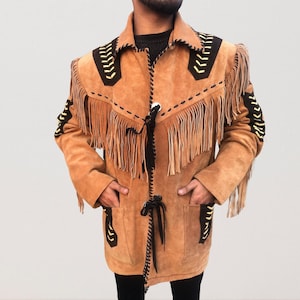 May include: A brown suede jacket with black and yellow stitching and fringe detailing. The jacket has a long, fitted silhouette and a button-up closure.