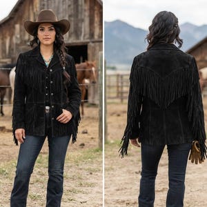 May include: A black suede jacket featuring long fringe detailing across the chest, back, and sleeves. The jacket has a collared neckline, a button-front closure, and long sleeves. The fringe hangs from the shoulders and upper back area.