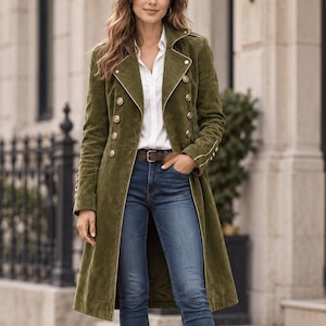 May include: An olive green long-line coat with gold-tone military-style buttons, worn over a white collared shirt and blue denim jeans. The outfit is completed with a brown leather belt and brown leather ankle boots with a block heel.