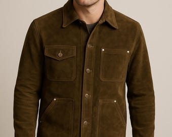 May include: Olive green suede jacket with a collared neckline, button-down closure, and four front pockets. The jacket has a classic design and is suitable for various occasions. The jacket is made of a soft, suede material.