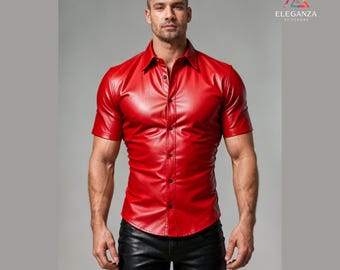 May include: A short-sleeved, red leather shirt with a button-down front. The shirt has a classic collar and is paired with black leather pants. The image features the "ELEGANZA STITCHERS" logo in the upper right corner.