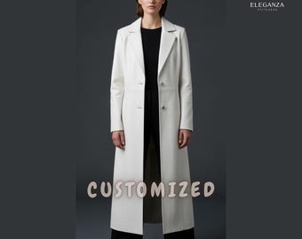 May include: A long, white coat with a tailored design. The coat features a classic lapel collar, two buttons, and a floor-length hemline. The word "CUSTOMIZED" is displayed across the bottom of the coat. The coat is worn over a black top and black pants.