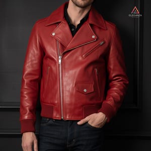 May include: A striking red leather jacket in a biker style. It has a notched collar, an asymmetrical zip, multiple zipped pockets, and ribbed cuffs and hem. This jacket is a bold fashion statement, perfect for a stylish look.